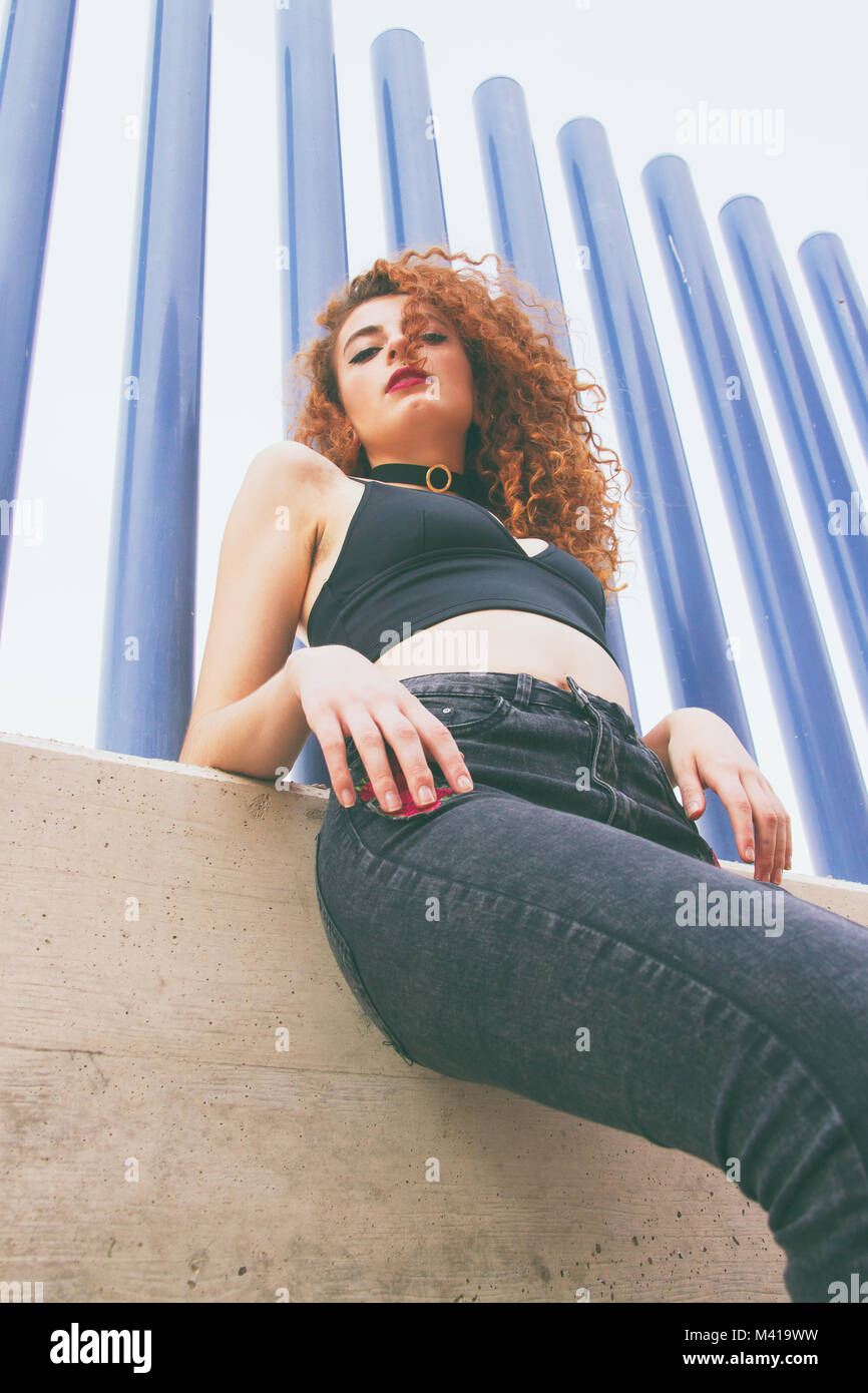 Young redhead model and a blue background Stock Photo - Alamy