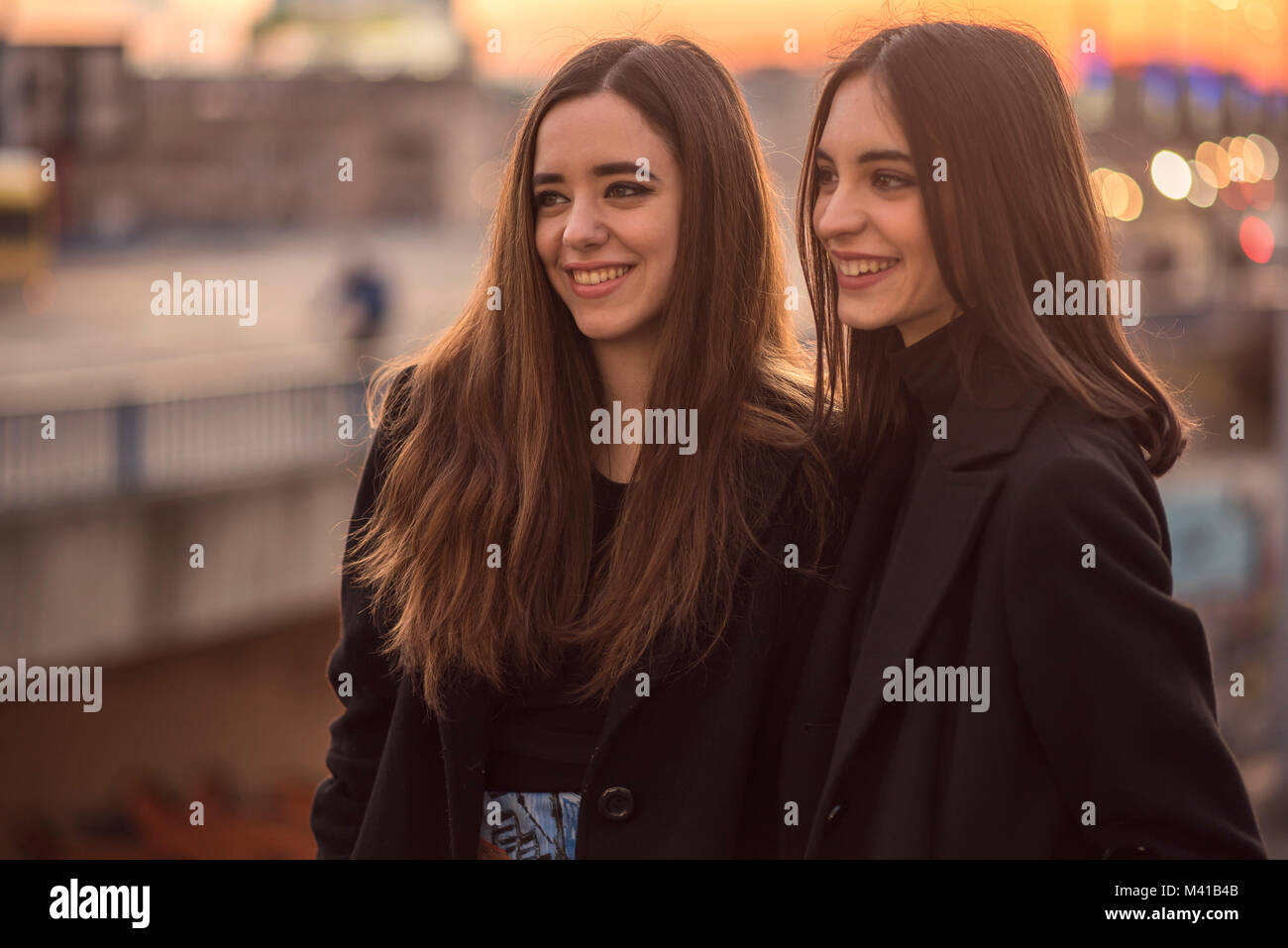 Two girls walking down street hi-res stock photography and images - Alamy