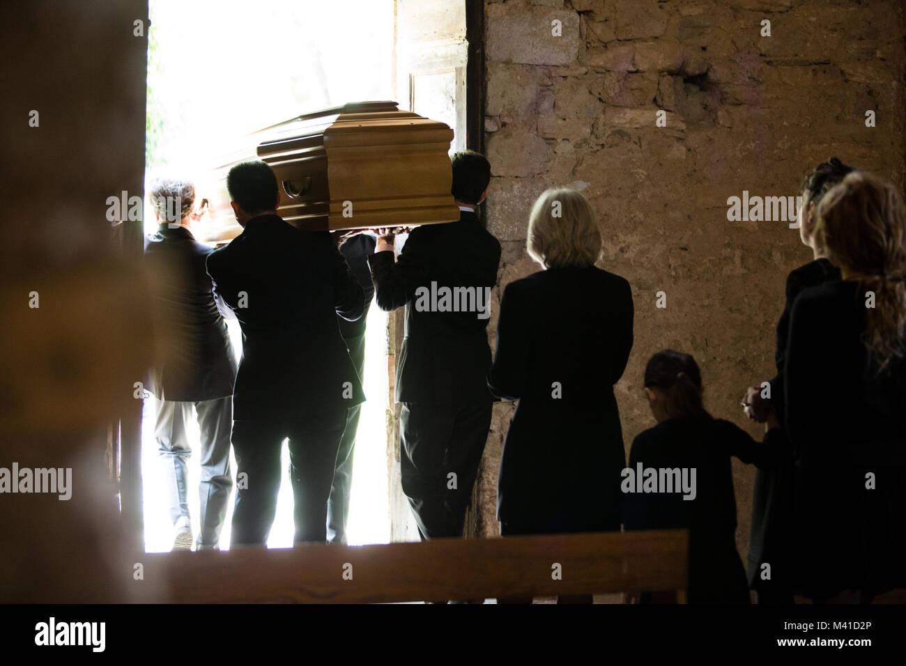 Family following coffin from church Stock Photo