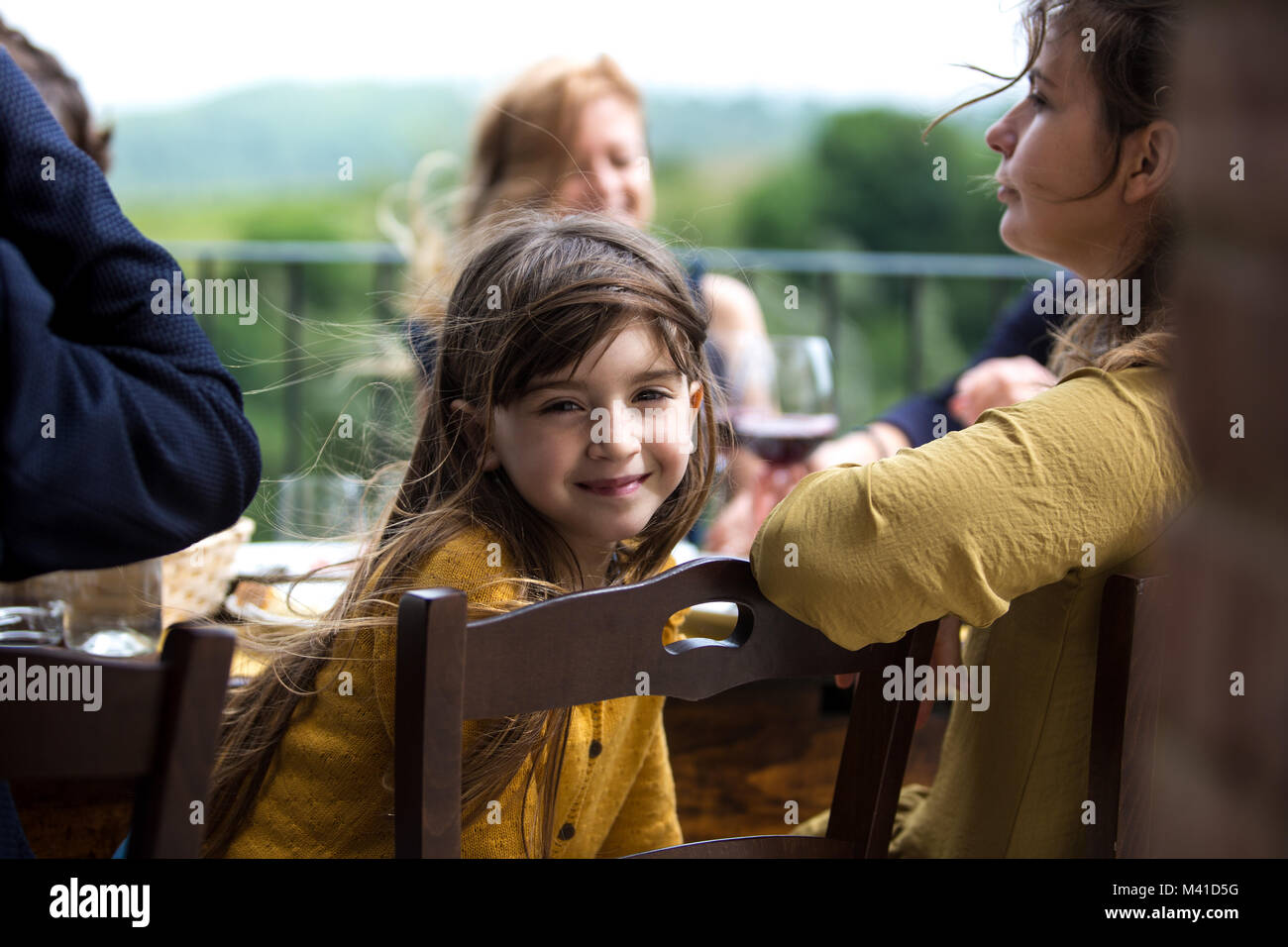 Portrait of girl at a family meal outdoors Stock Photo