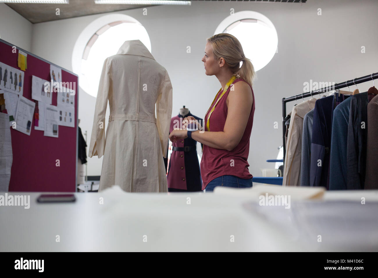 Fashion designer working on garment Stock Photo