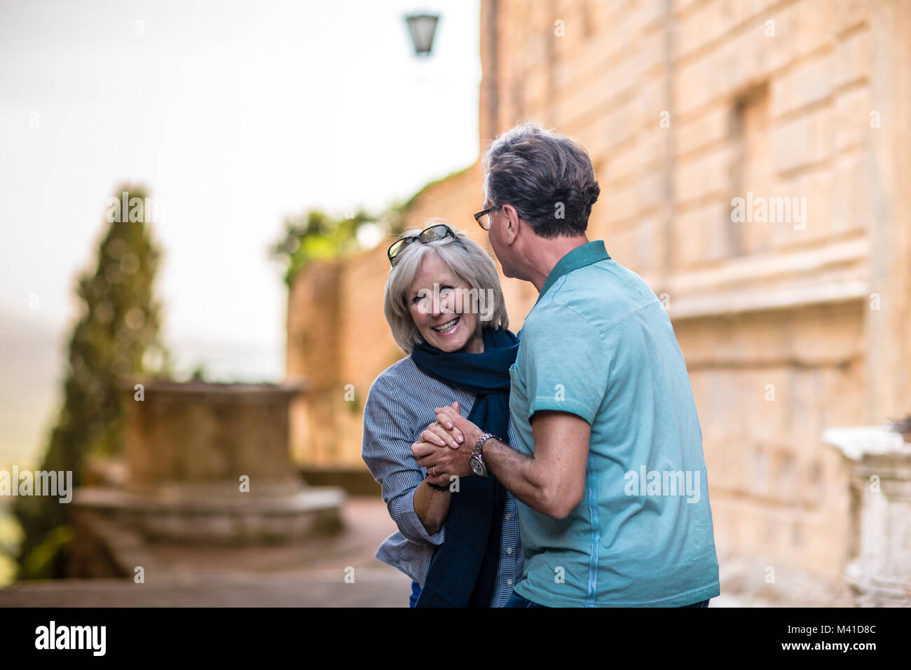 Senior couple dancing in the street on vacation Stock Photo