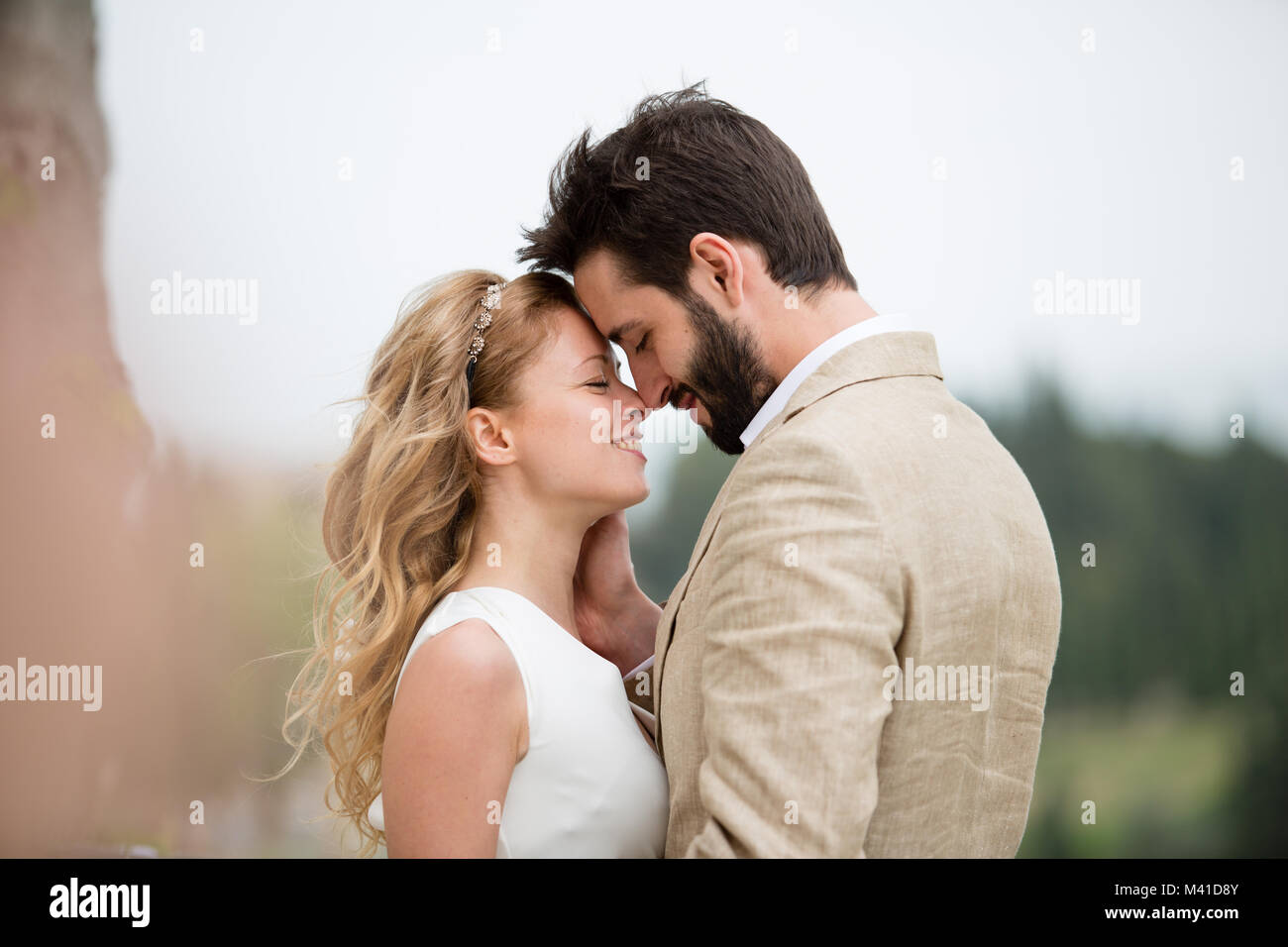 Bridge and Groom being romantic outdoors Stock Photo