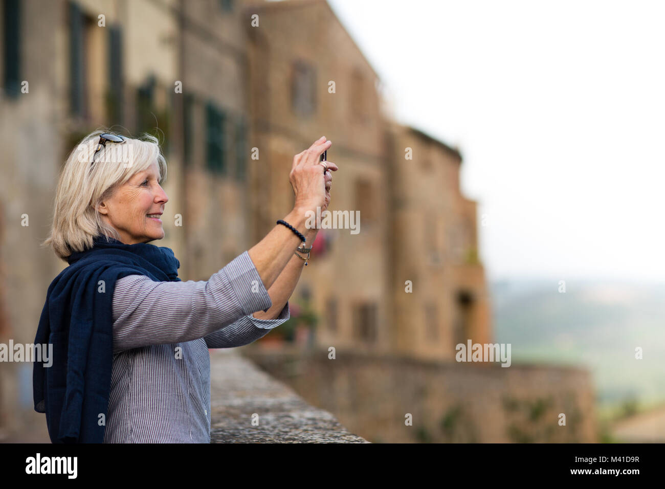 Senior woman on vacation taking a photo Stock Photo