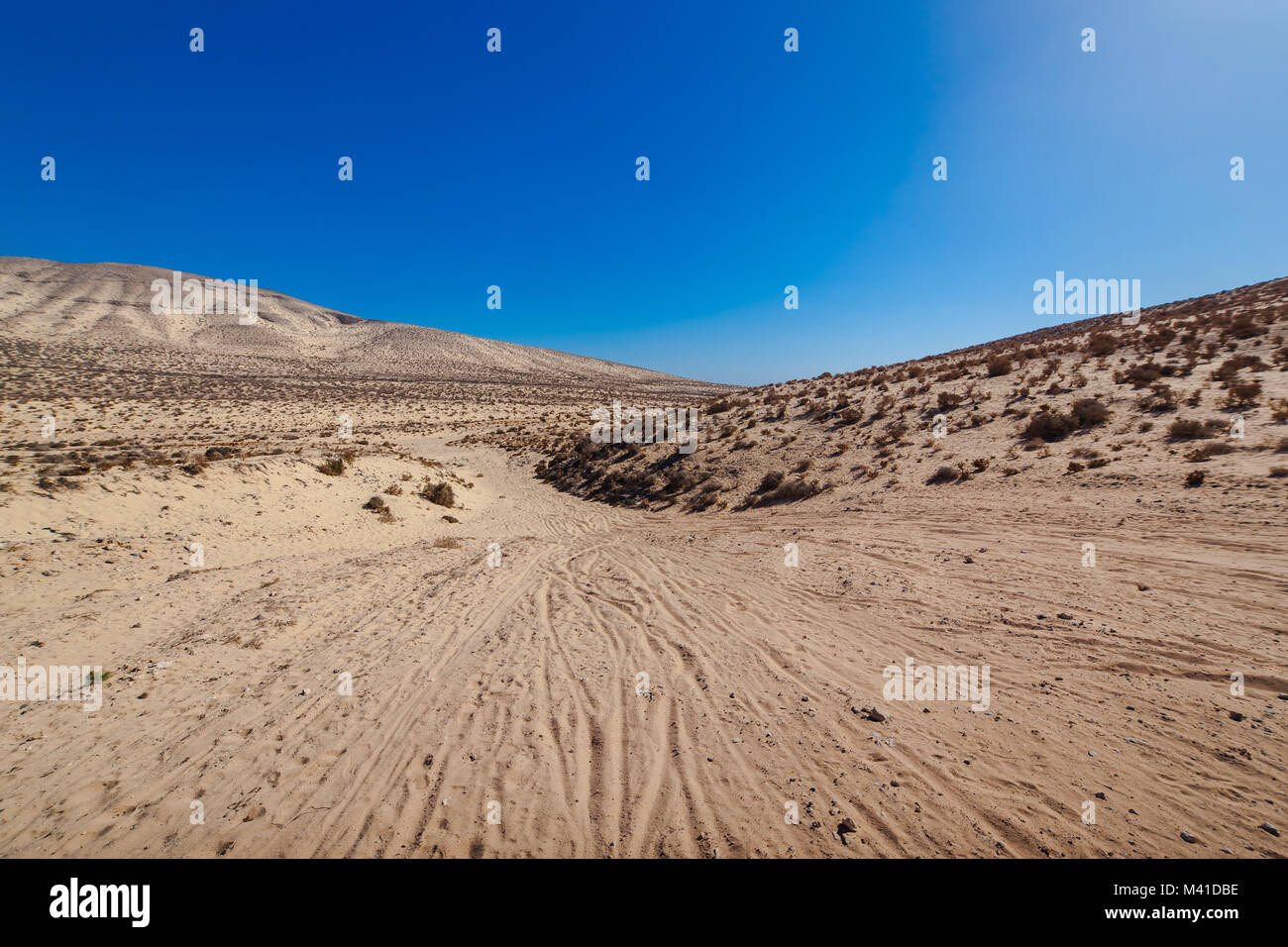 Sotavento, Risco Del Paso desert with yellow sand mountains on the horizon. Risco Del Paso near Jandia, Fuerteventura, Spain. Stock Photo