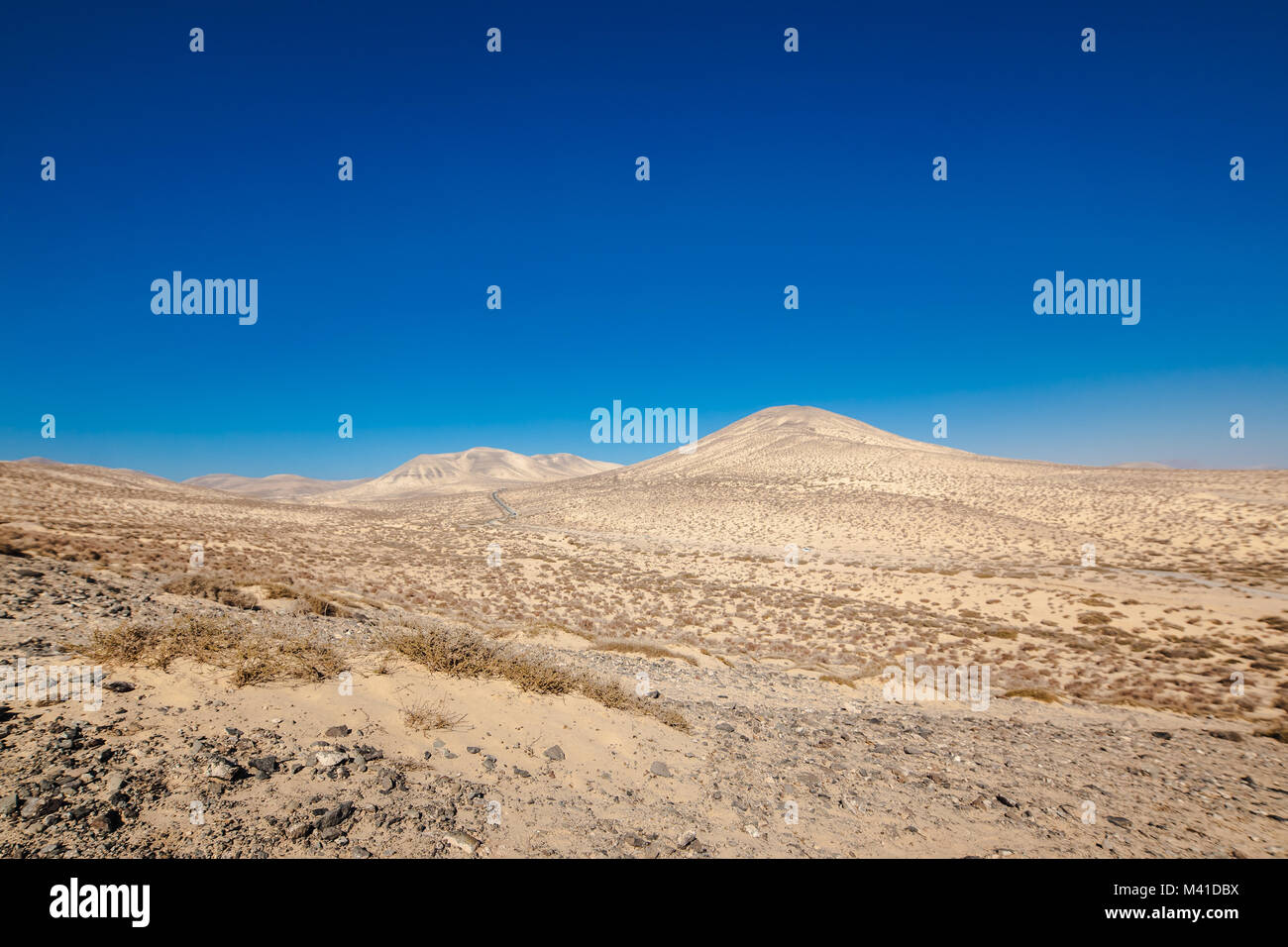 Sotavento, Risco Del Paso desert with yellow sand mountains on the horizon. Risco Del Paso near Jandia, Fuerteventura, Spain. Stock Photo