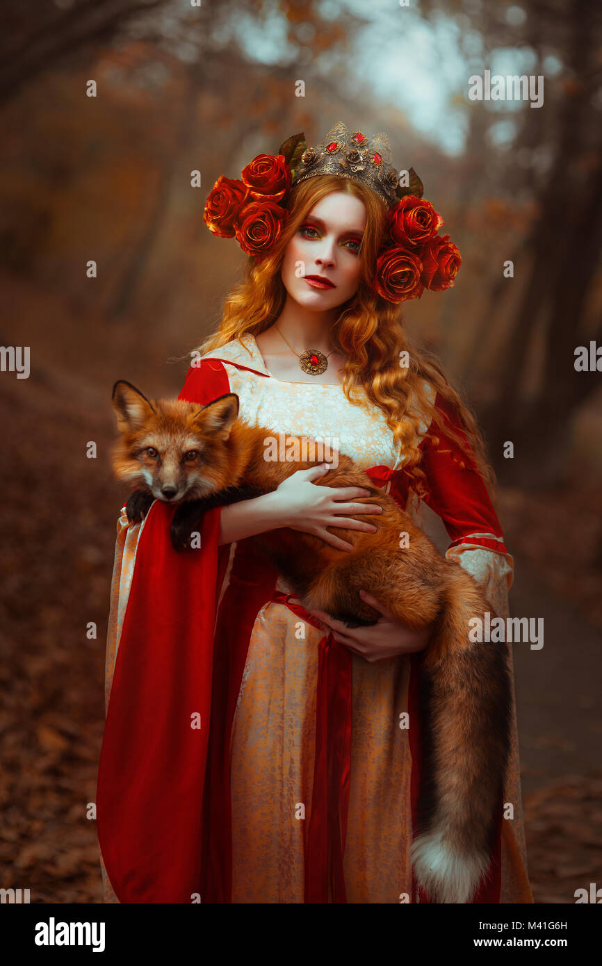 Woman in medieval clothes with a fox Stock Photo