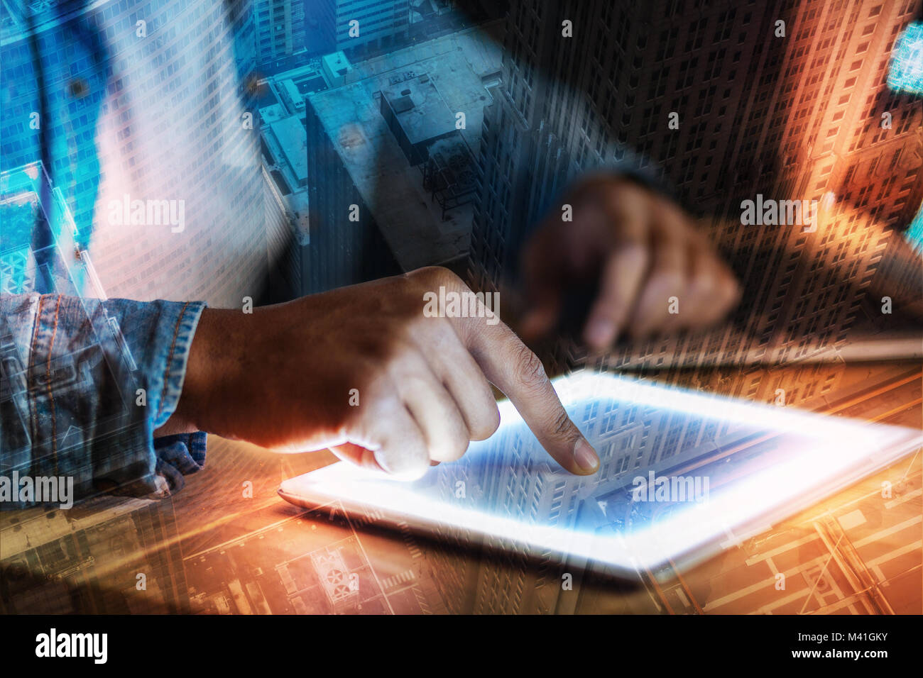 Young person touching the screen of a tablet while working Stock Photo