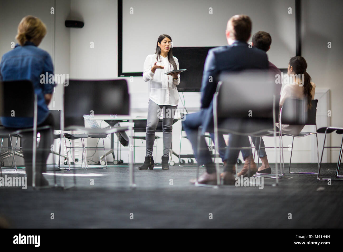 Female executive leading a  training conference Stock Photo