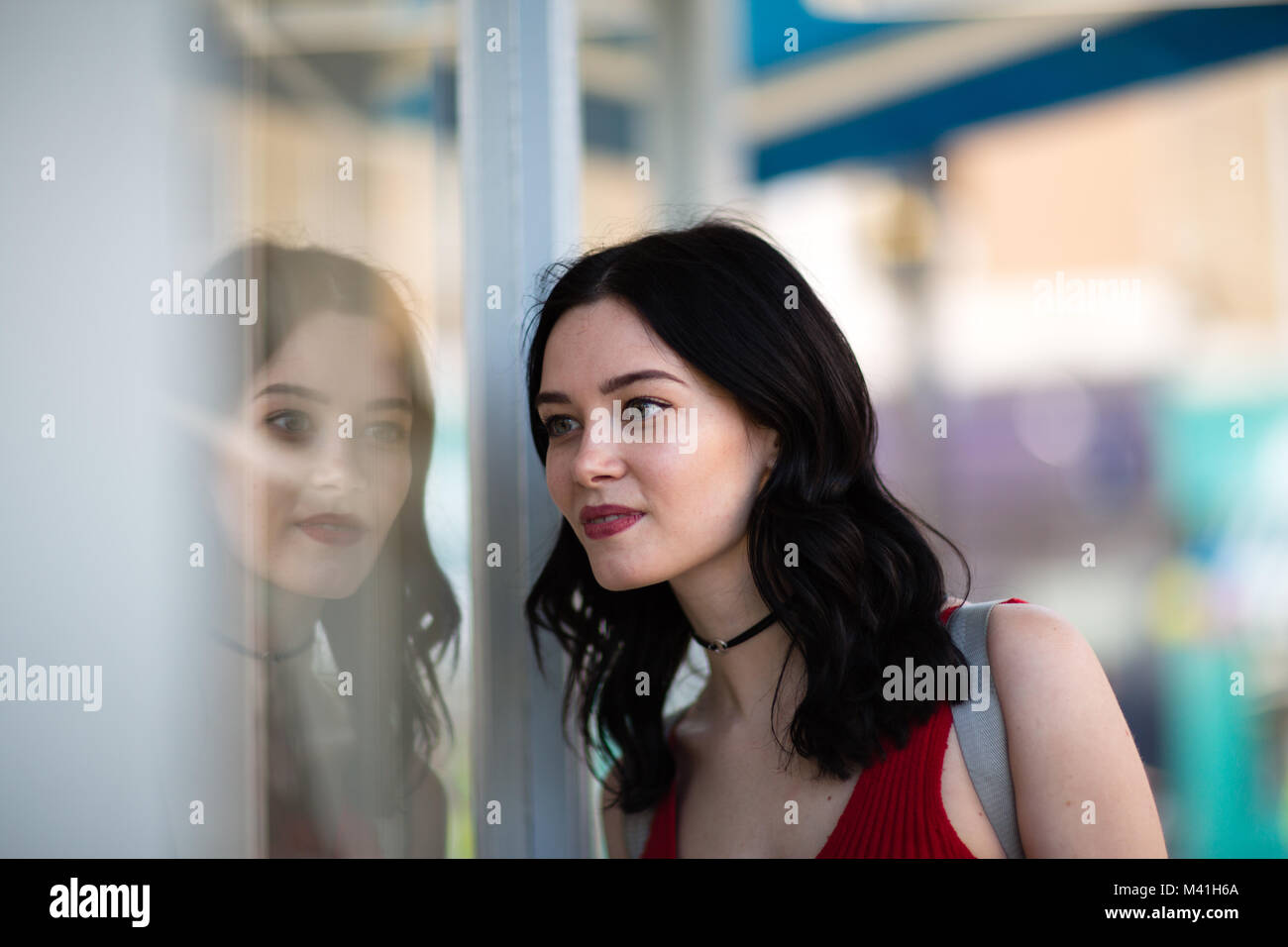 Young adult female window shopping in summer Stock Photo