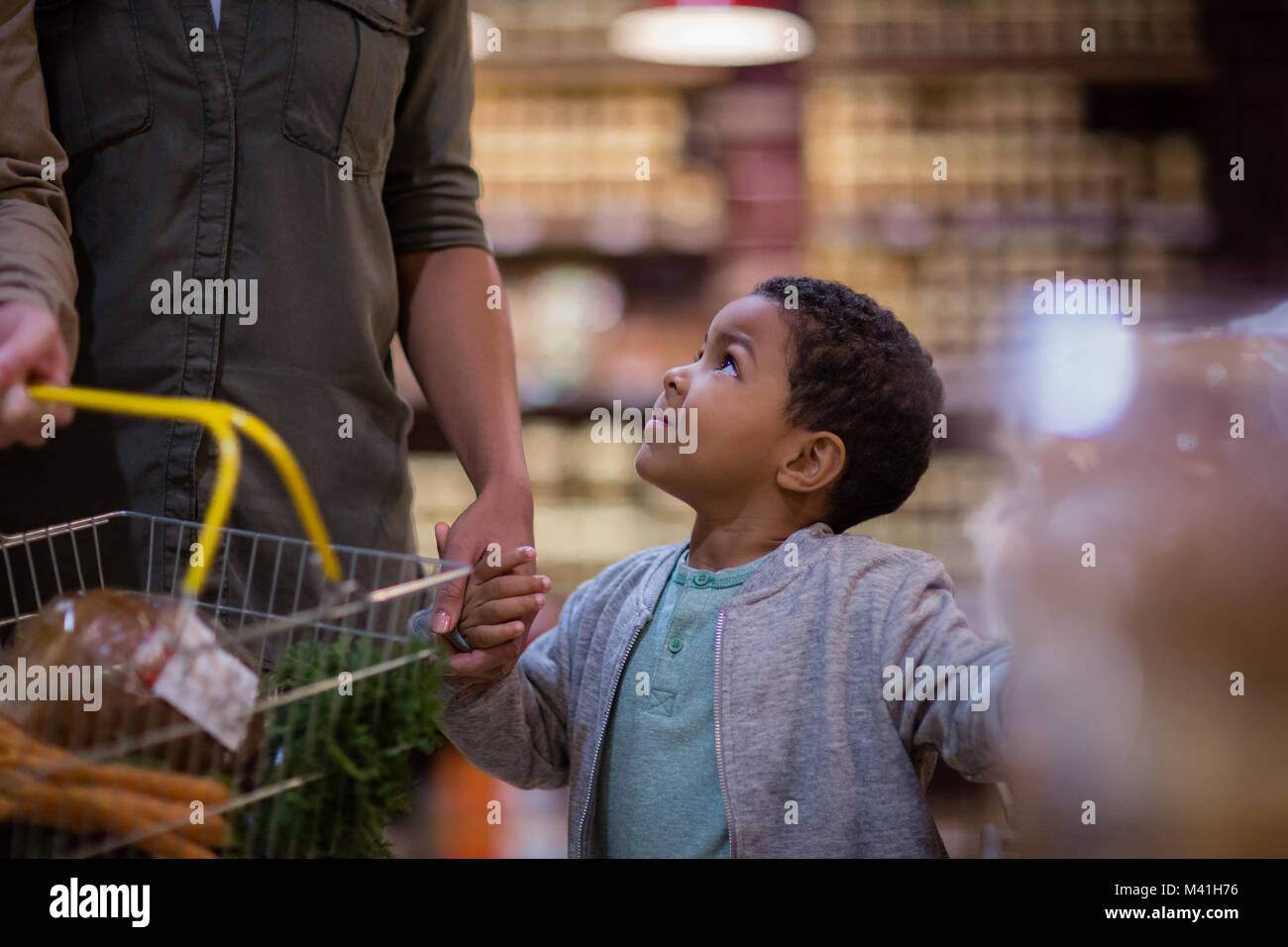 Mother and son doing weekly shop in grocery store Stock Photo