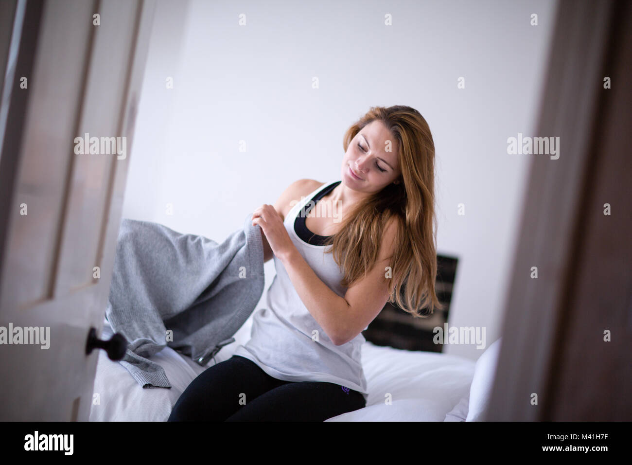 Young adult female getting dressed in the morning Stock Photo