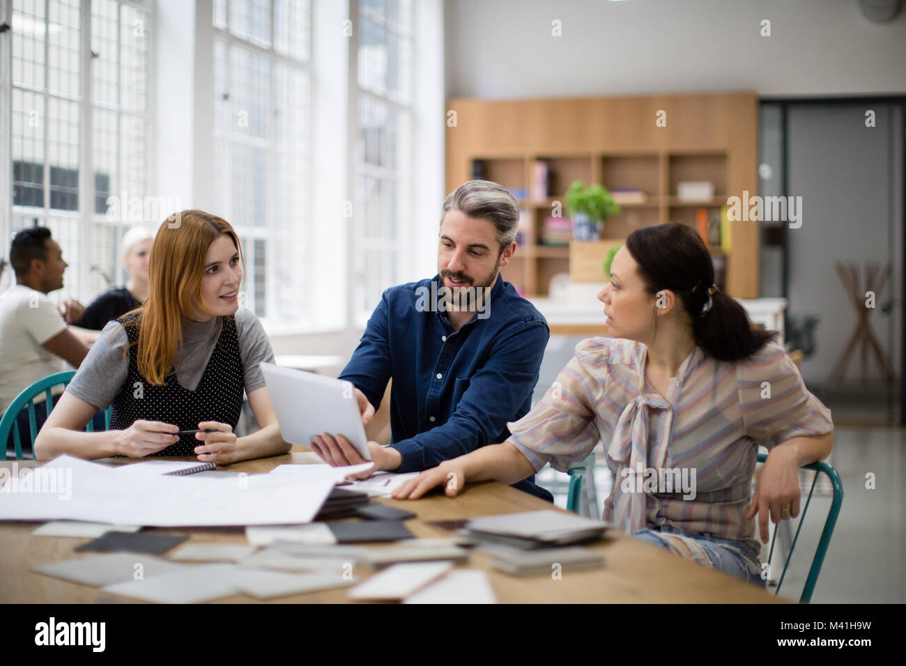 Group of coworkers discussing a project Stock Photo
