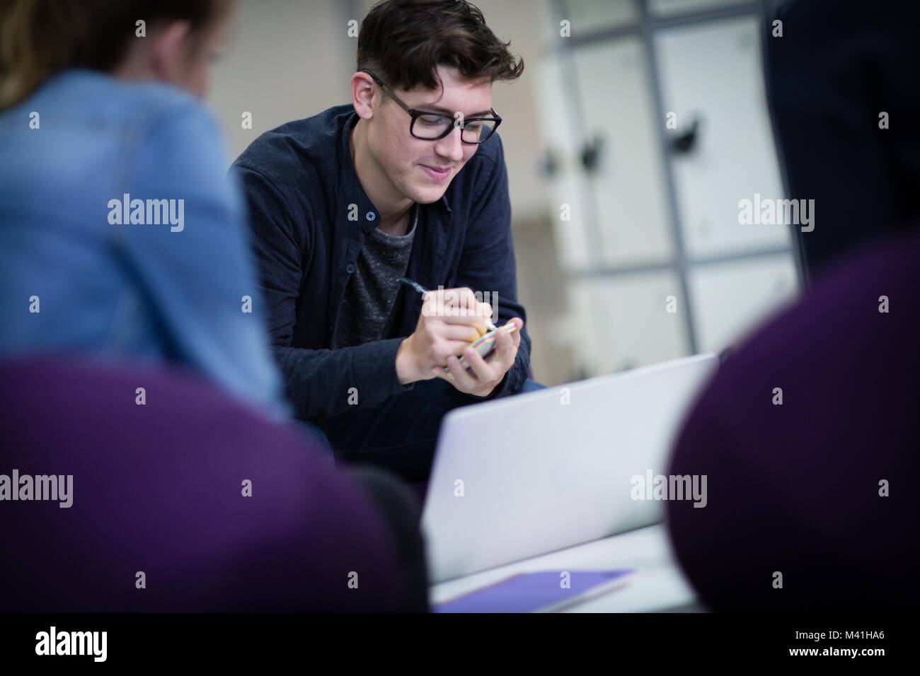Student writing a note at college Stock Photo