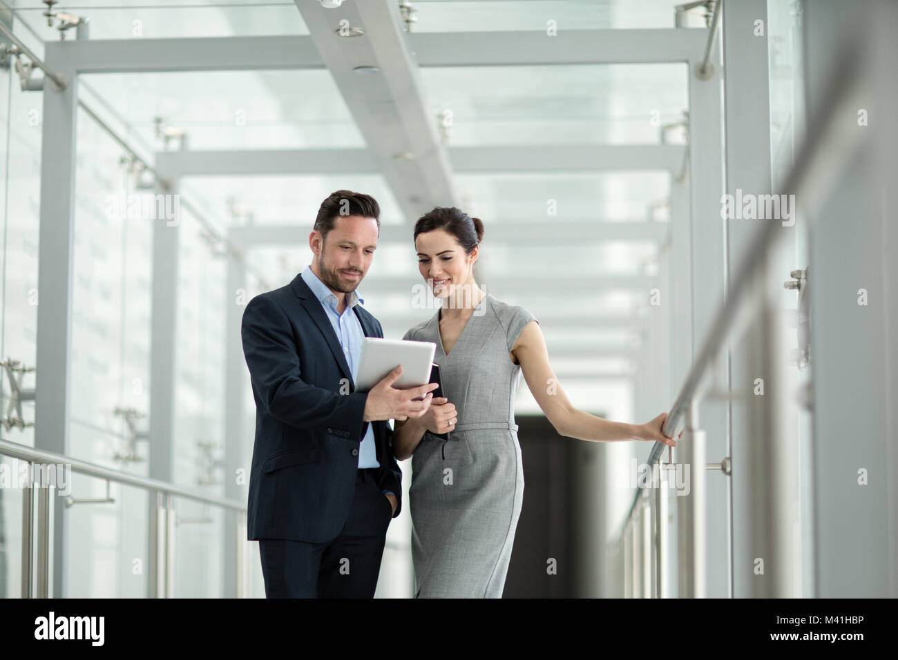 Business colleagues looking at digital tablet together Stock Photo