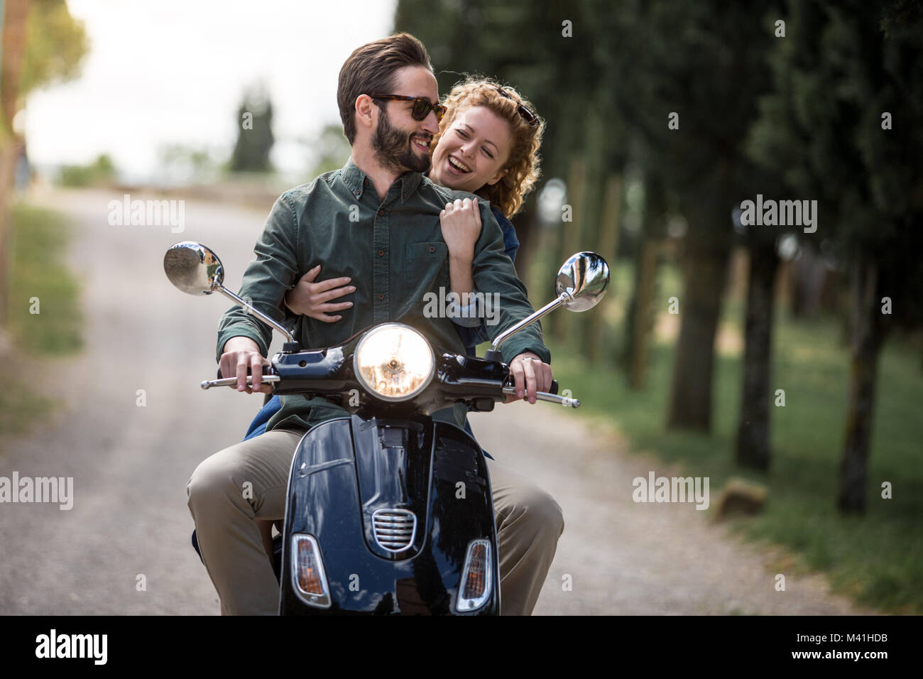 Young couple on motorbike together Stock Photo