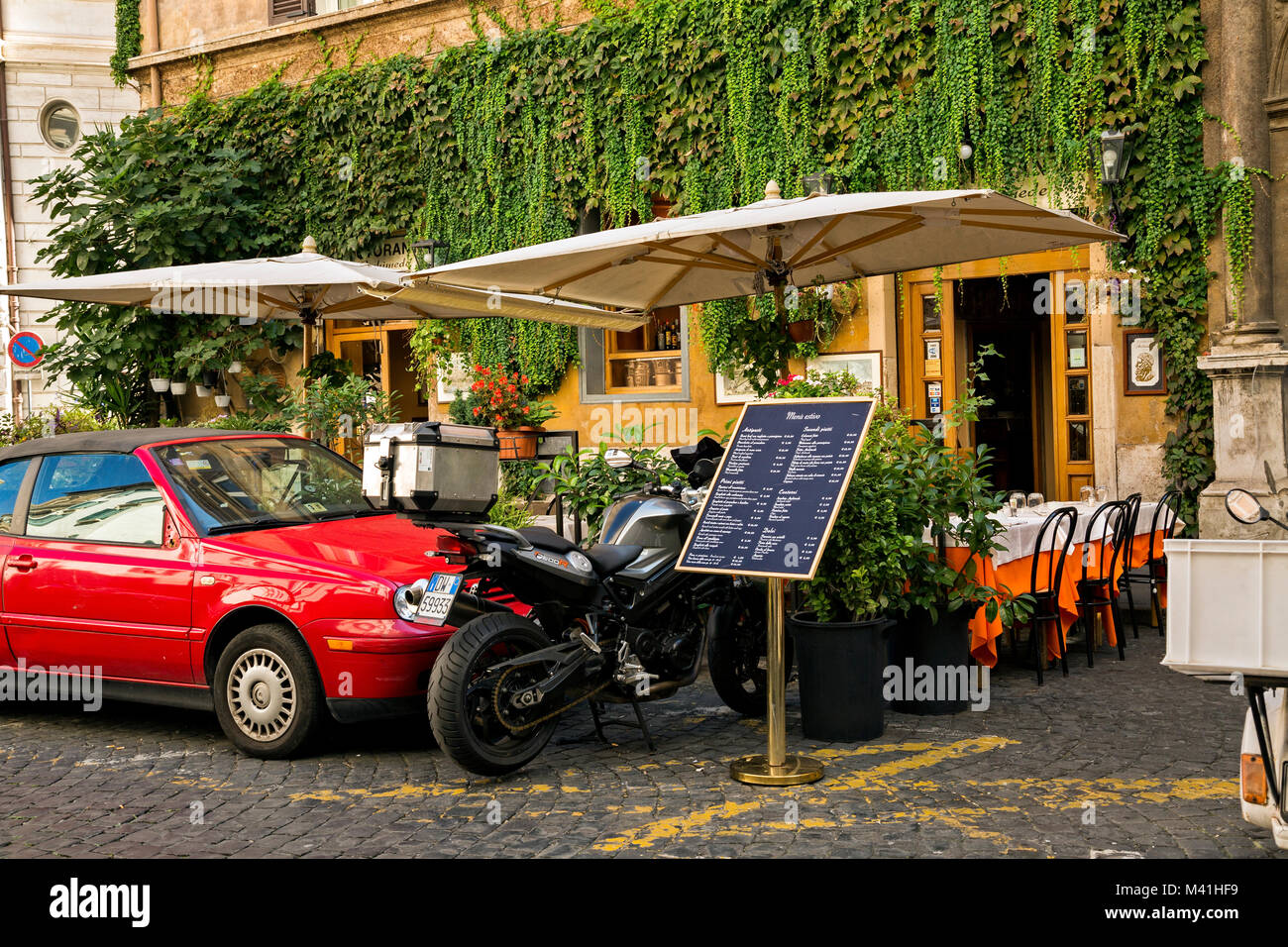 Restaurant in Rome preparing for the day's business. Setting up tables in preparation for the day's beginning. Stock Photo