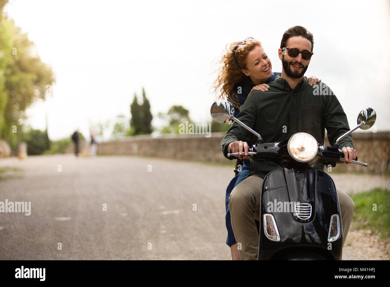 Young couple on motorbike together Stock Photo