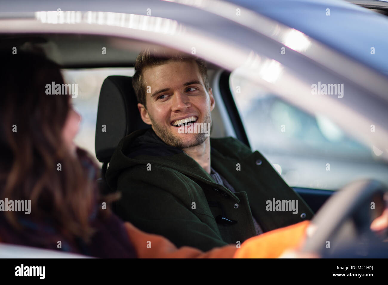 Passenger smiling at driver Stock Photo
