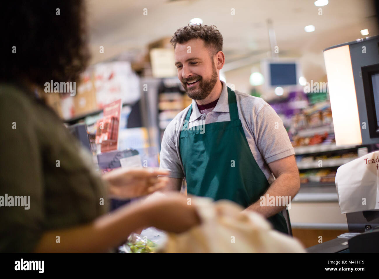 Woman at grocery checkout scan Stock Photo