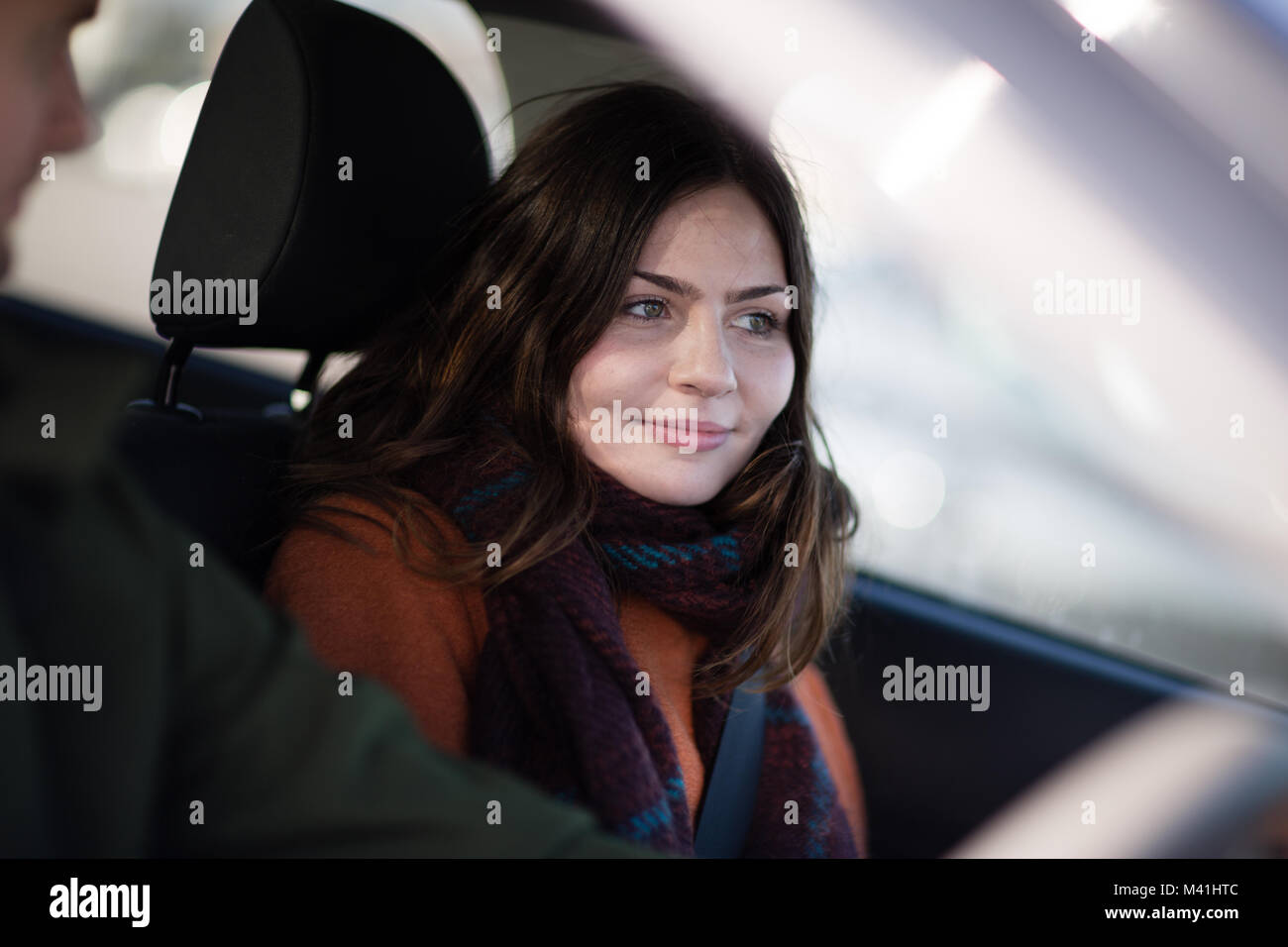 Passenger smiling at road ahead Stock Photo