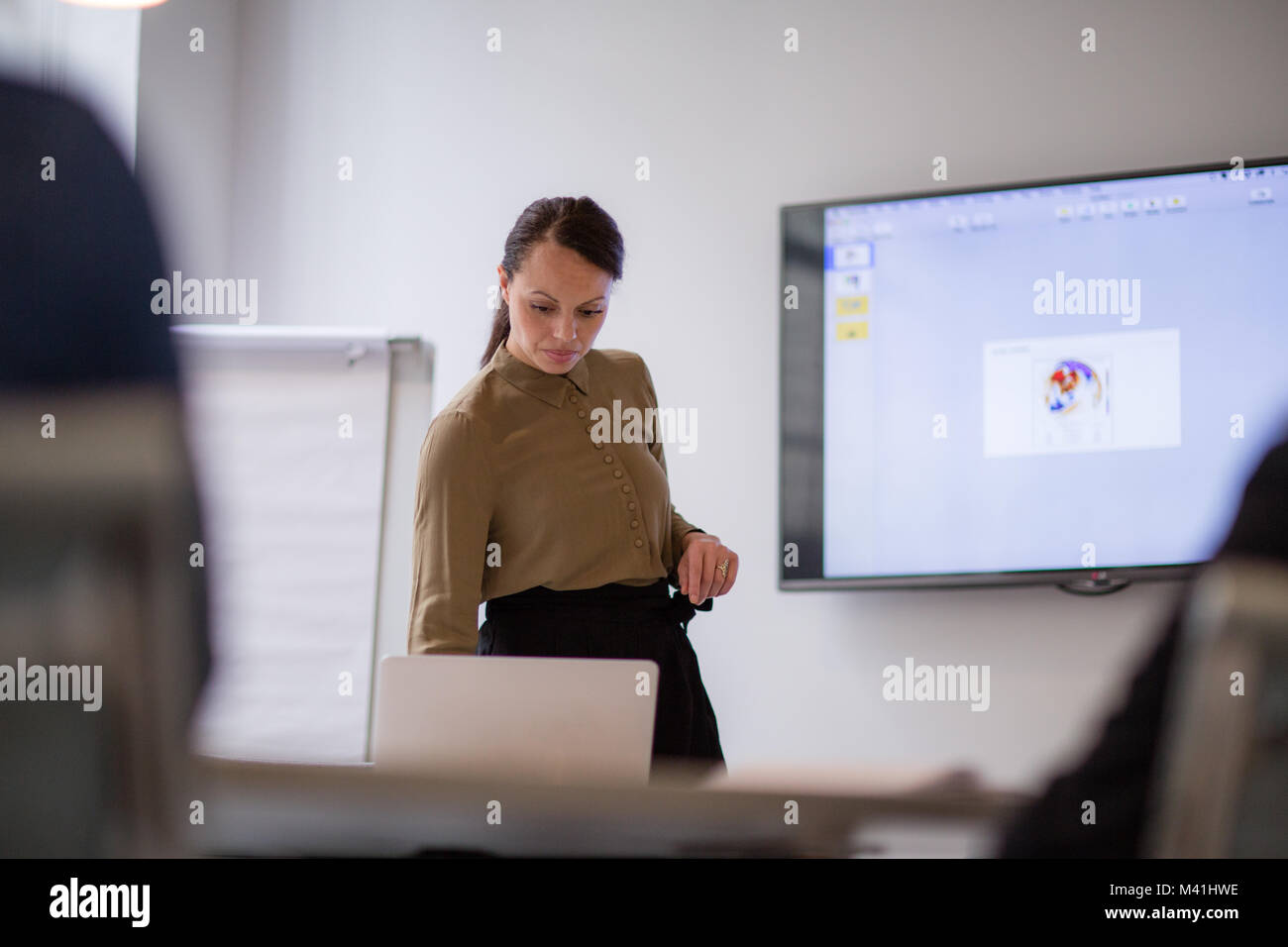 Female business executive setting up a presentation Stock Photo