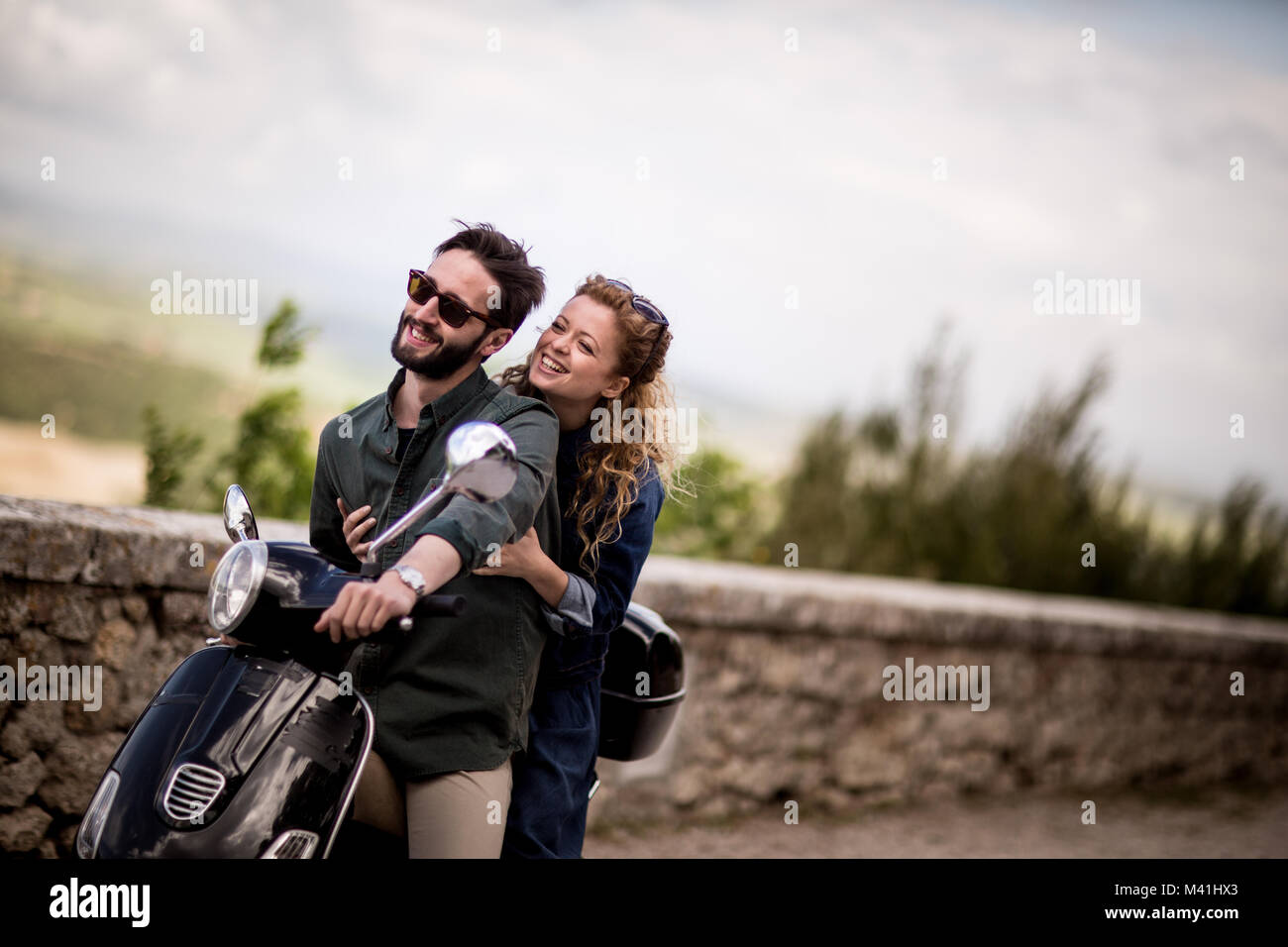 Young couple on motorbike together Stock Photo