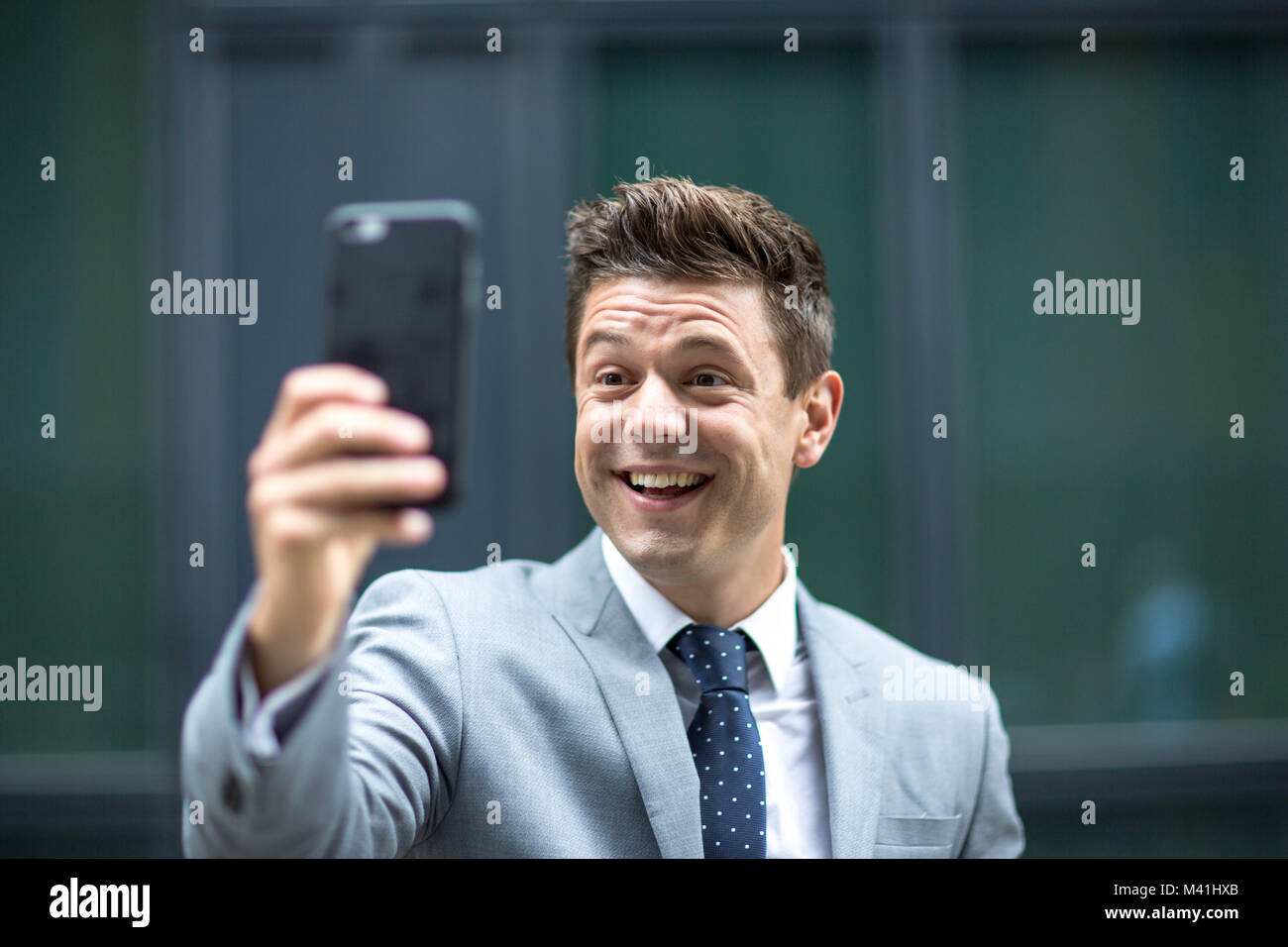 Smiling man on video call outdoors Stock Photo