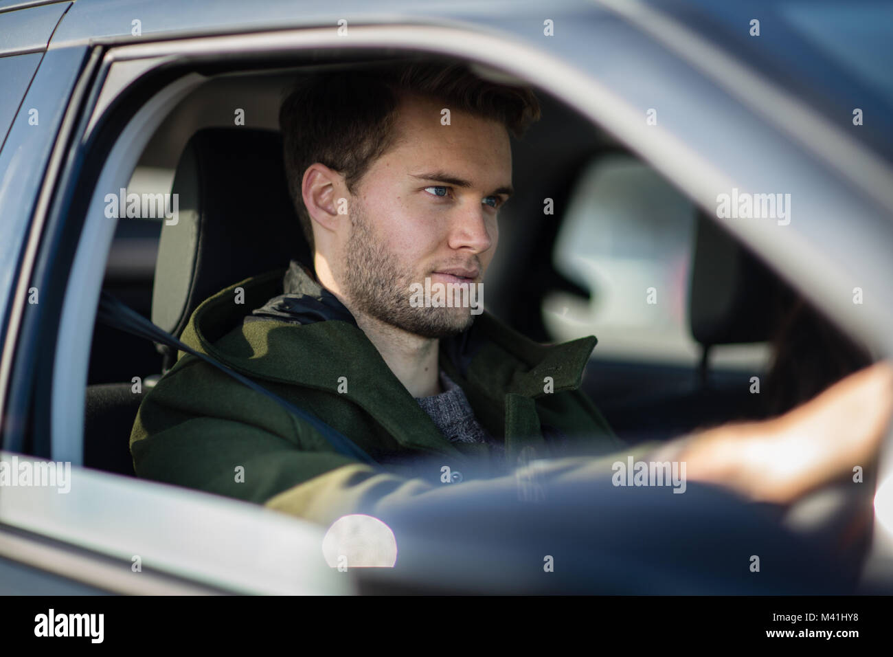 Young adult male driving car Stock Photo