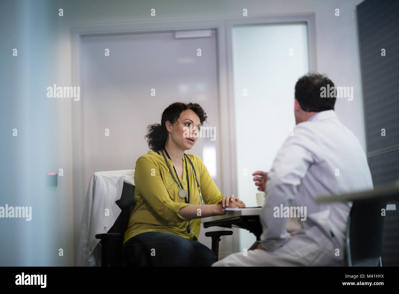 Medical Doctors discussing patient treatment together Stock Photo