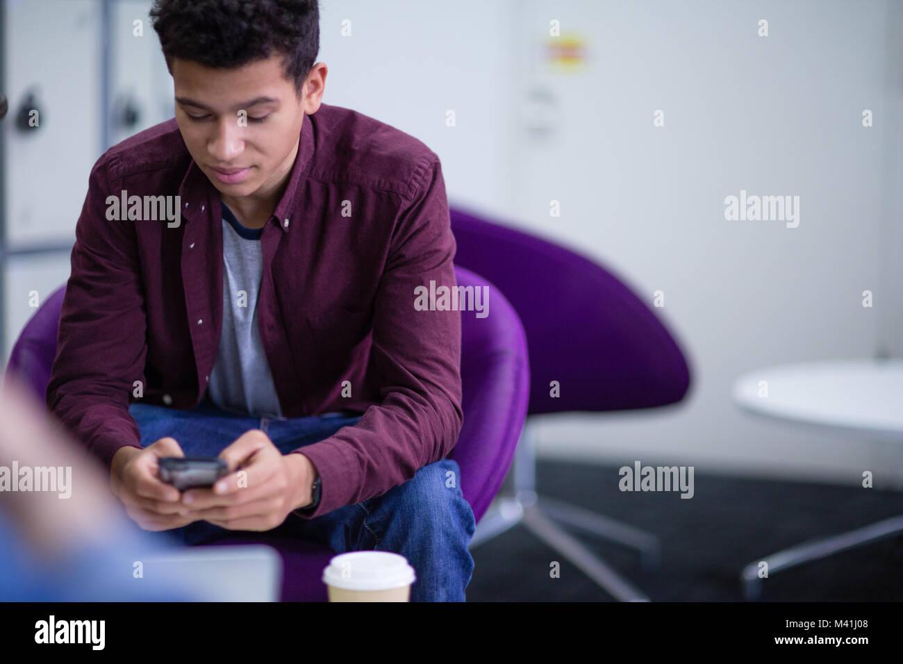 Student using smartphone at college Stock Photo