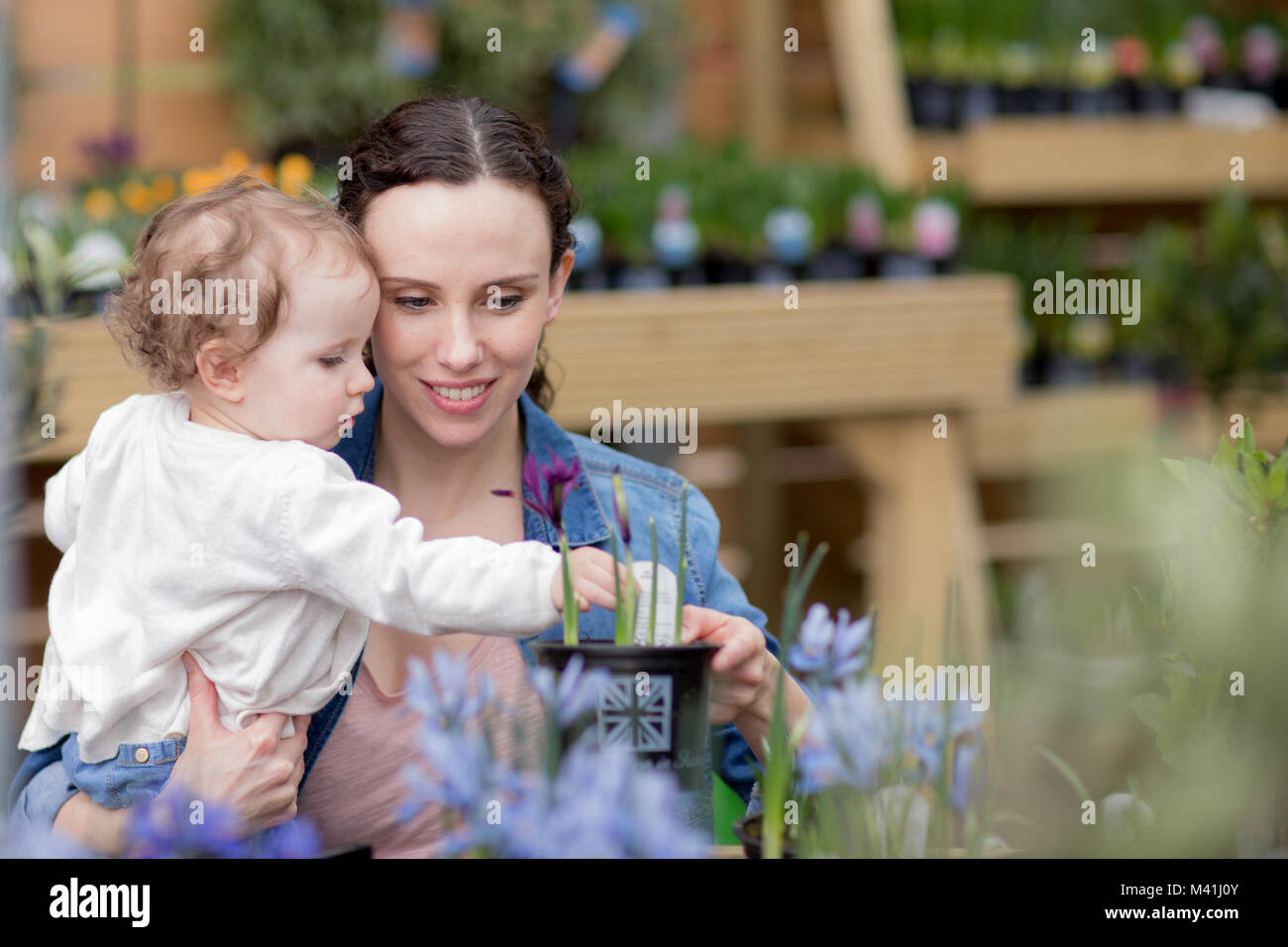 Mother with daughter at garden centre Stock Photo
