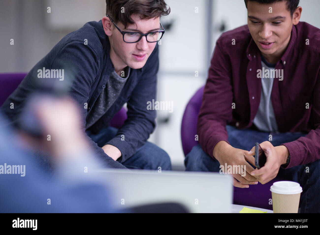 Male students working together Stock Photo