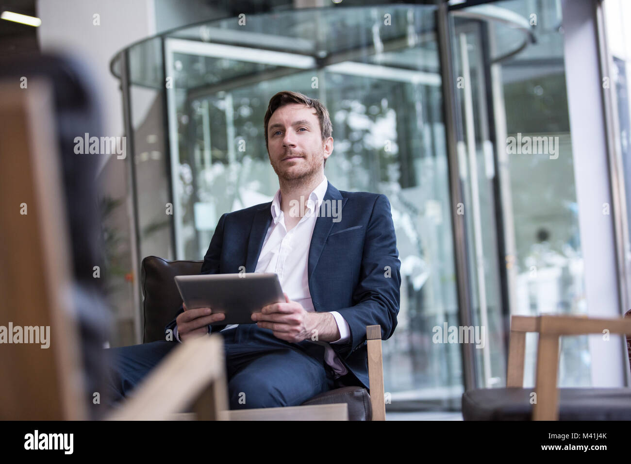 Businessman waiting in office reception Stock Photo