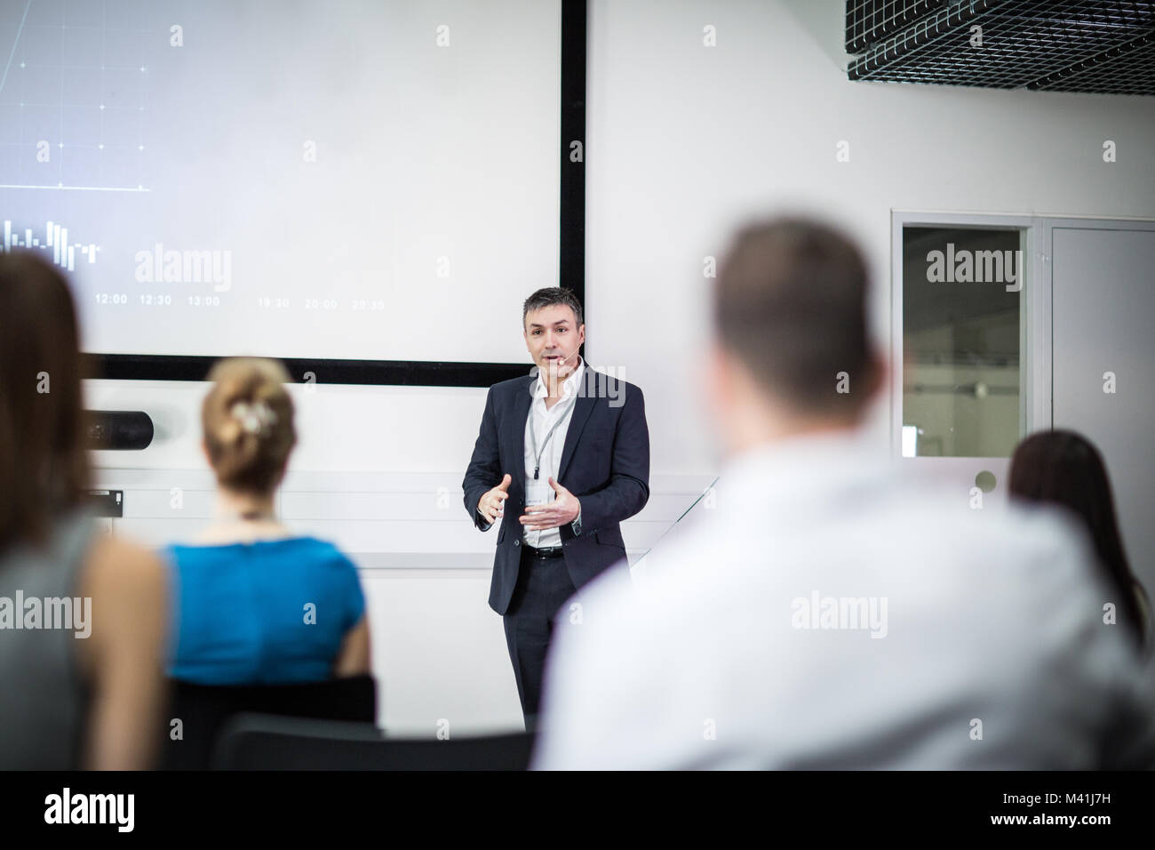 Speaker at a business training conference taking a question Stock Photo