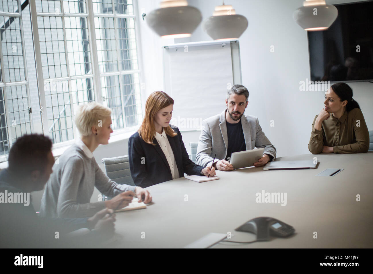 Male business executive leading a meeting Stock Photo