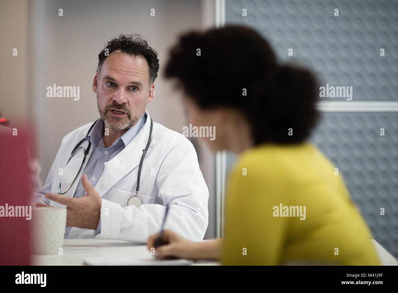 Medical Doctors discussing patient treatment together Stock Photo