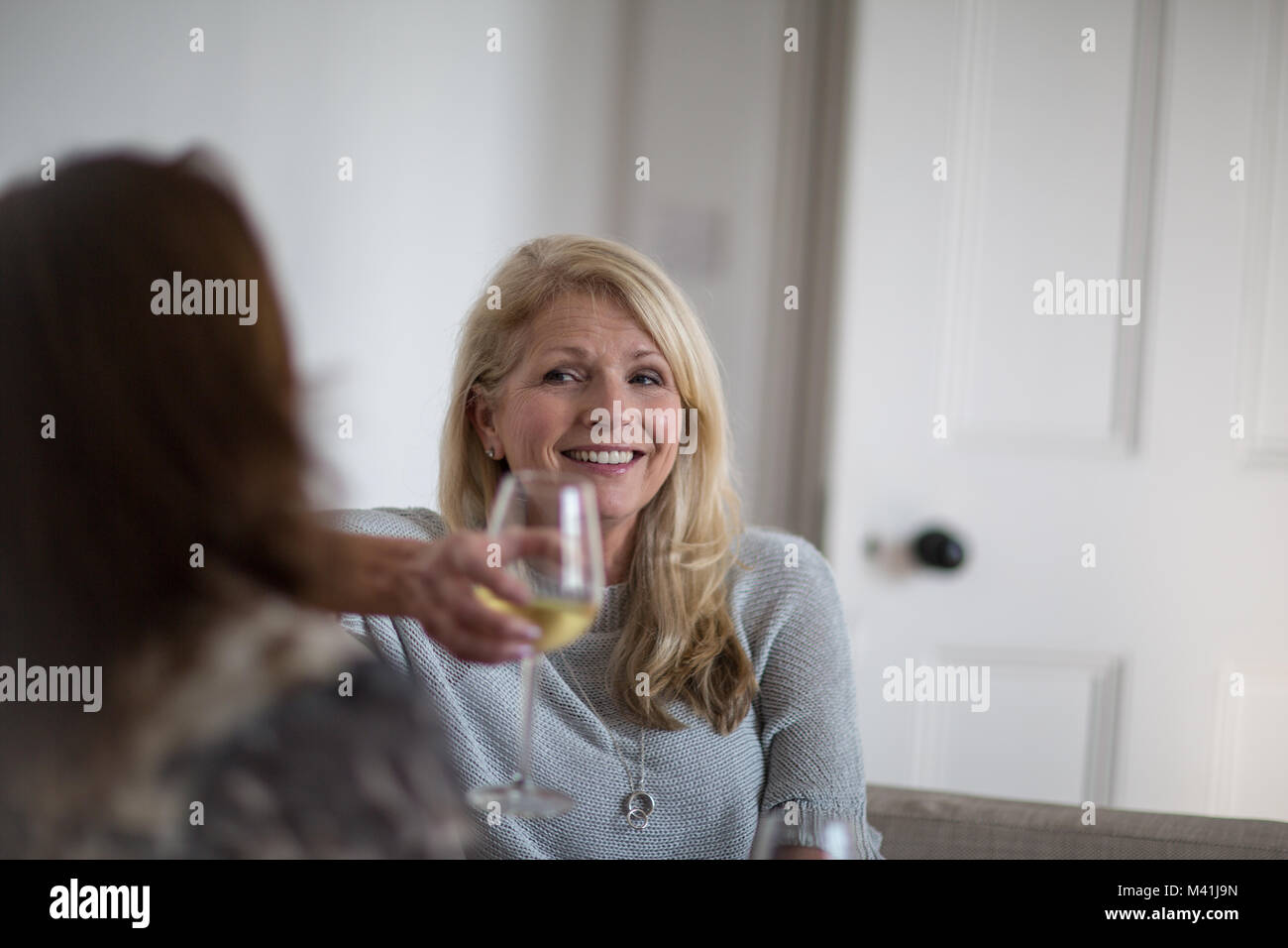 Mature female friends having a glass of wine Stock Photo