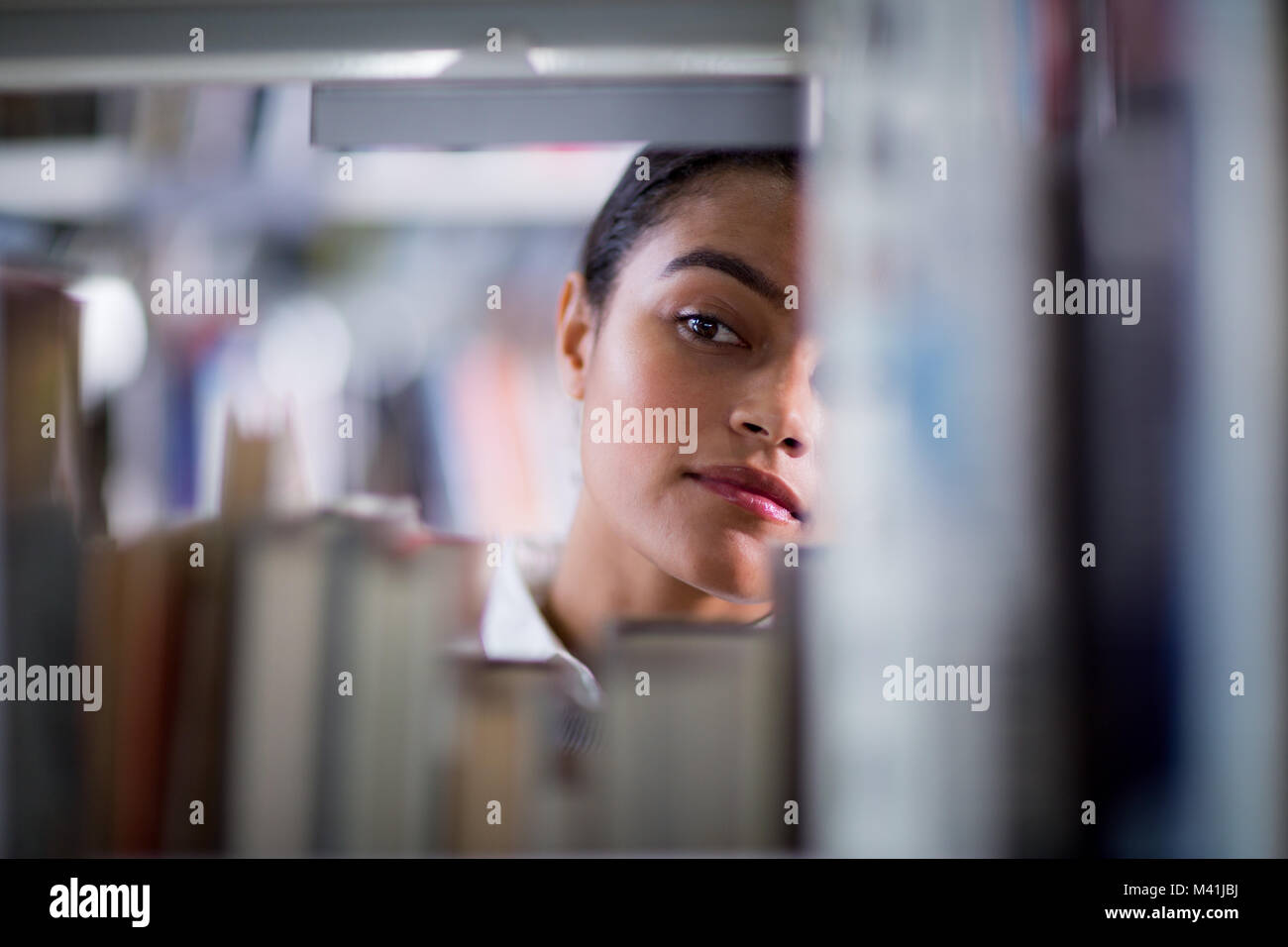 Student looking for a book in library Stock Photo