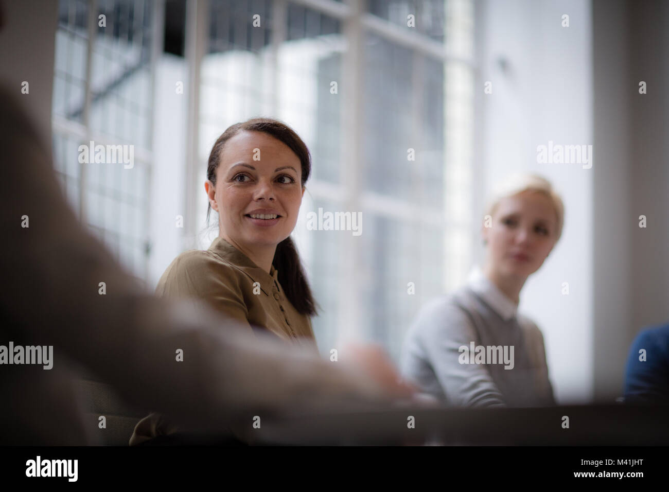 Businesswoman listening in a meeting Stock Photo