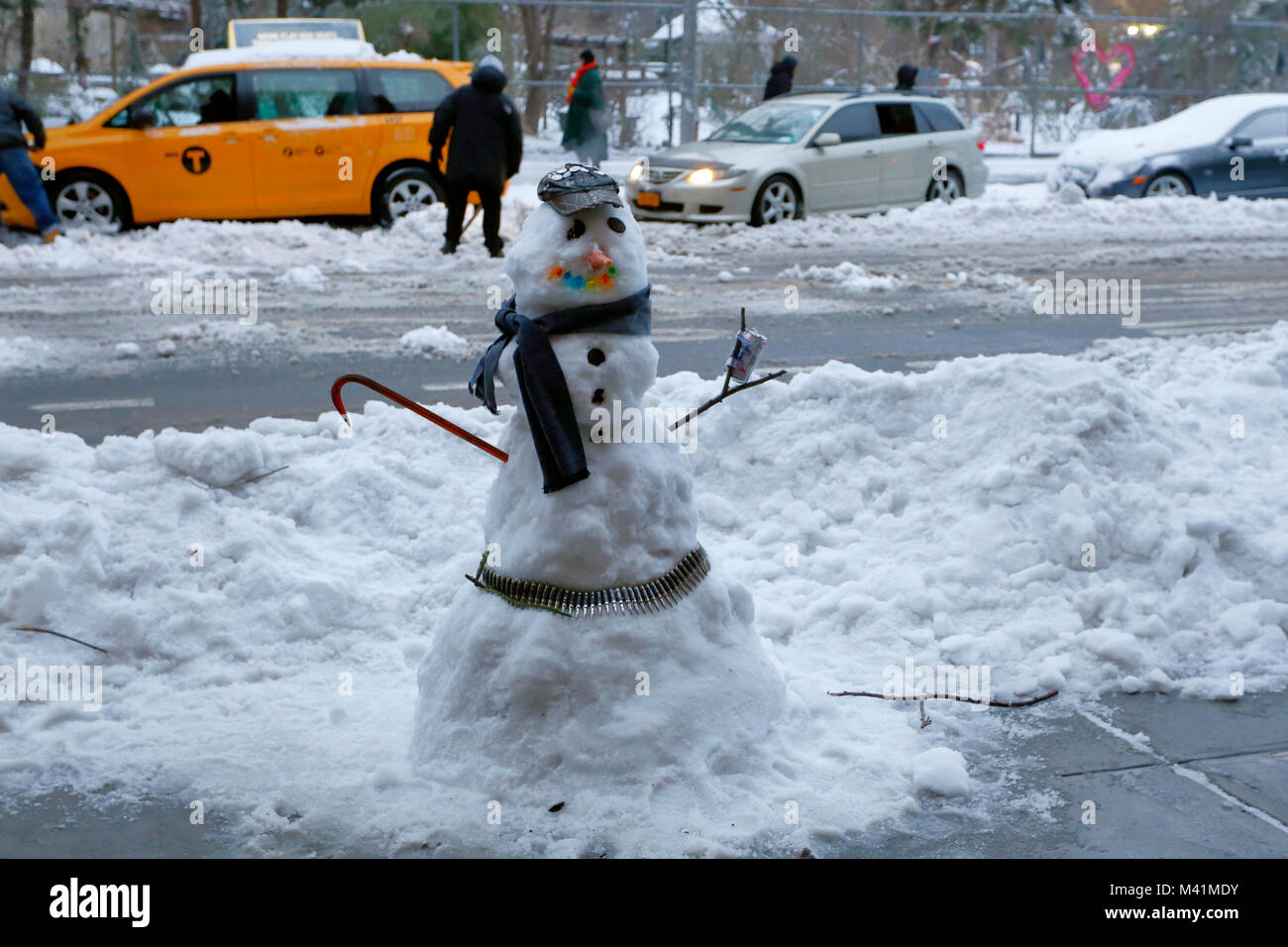 A snowman dressed with a crowbar and ammunition belt outside C-Square in Manhattan's East Village, New York City. Stock Photo