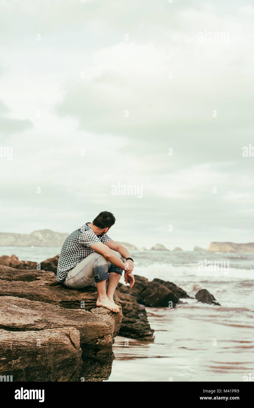 Young man enjoying the day in the beach Stock Photo