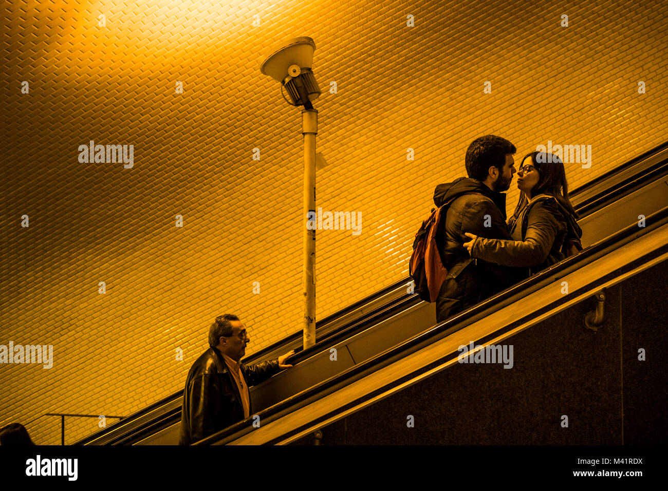 A couple kiss on the Baixa-Chiado metro station escalators in Lisbon, Portugal. Stock Photo
