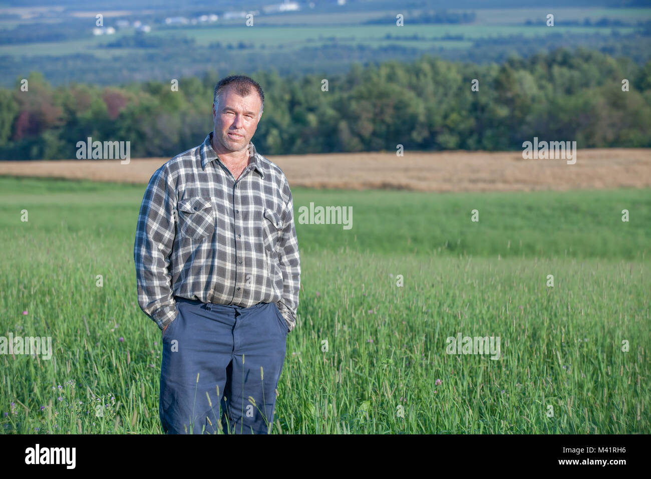 Proud farmer standing in his cultivated field Stock Photo - Alamy