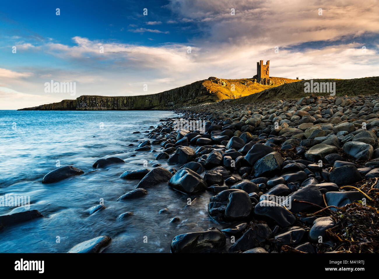 A photograph of Dunstanburgh Castle in Northumberland. Stock Photo