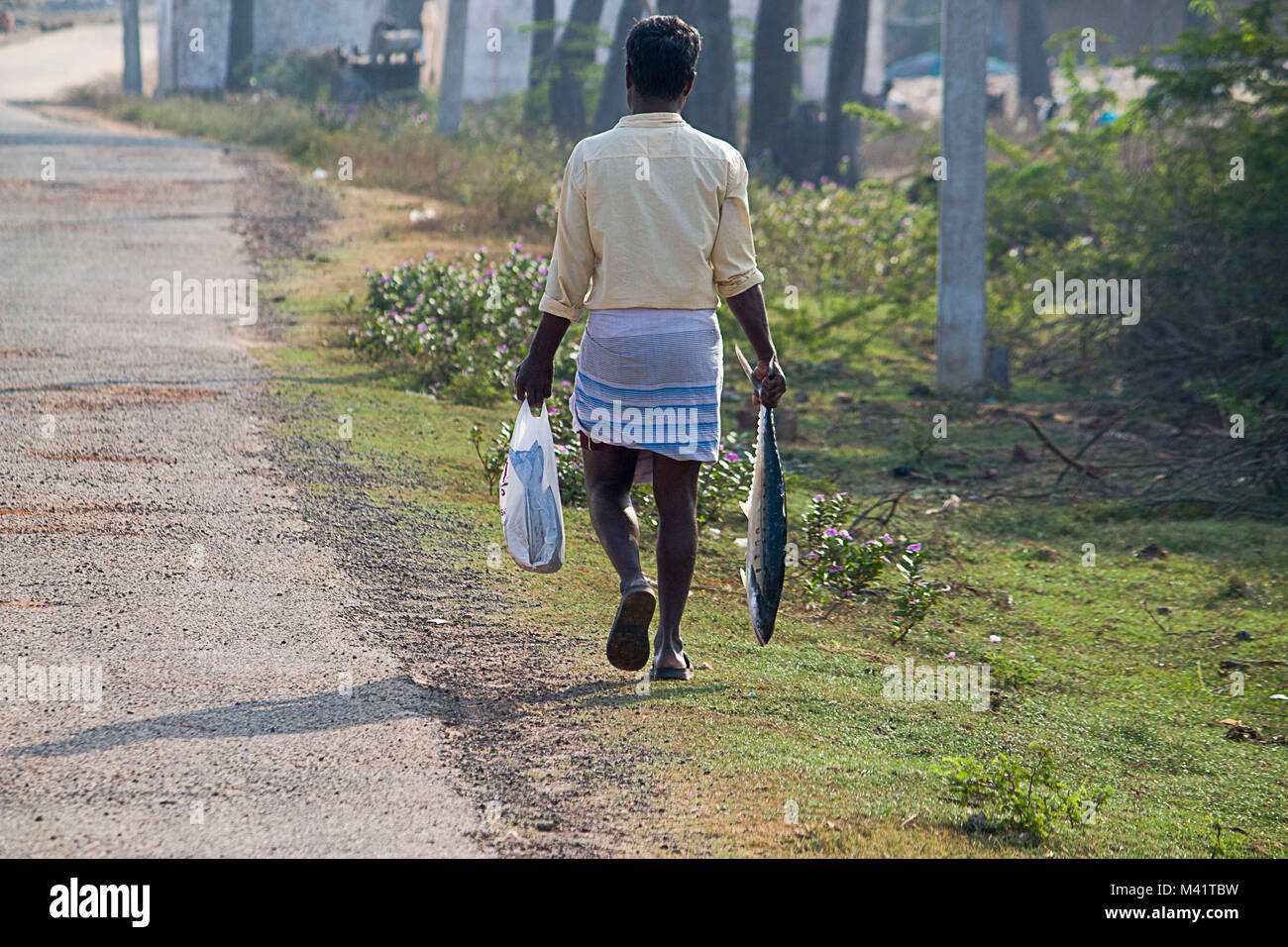 A Man Carrying Fish Stock Photo Alamy