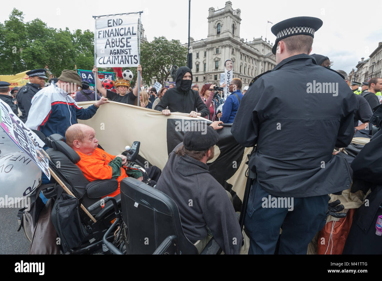 Police grab the giant 'Balls 2 the Budget' banner from DPAC protesters during the budget day rally on the road in Parliament Square. Stock Photo