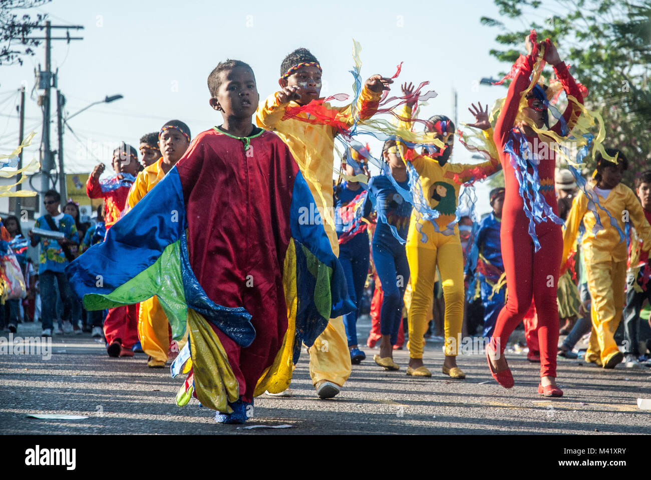Children wearing colorful costumes and dancing and participating in a parade during the Barranquilla Carnival Stock Photo