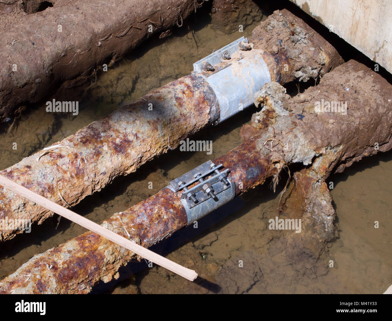 Rusty water pipes with embedded holes Stock Photo Alamy