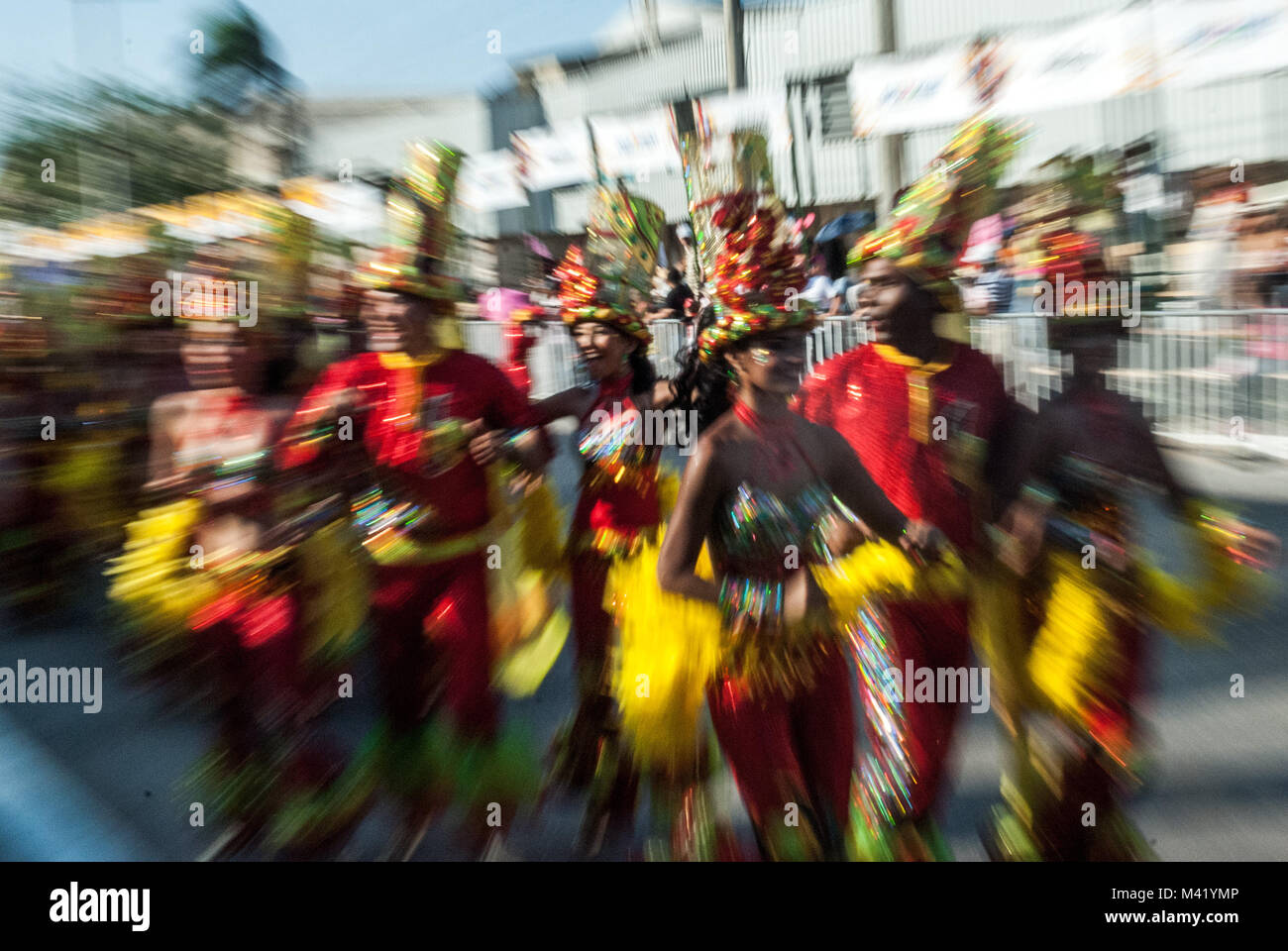 Zoom blur effect photo of happy dancers in bright costumes at the Barranquilla Carnival in Colombia Stock Photo